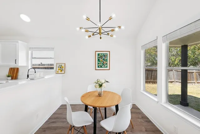 a view of a dining room with furniture window and wooden floor