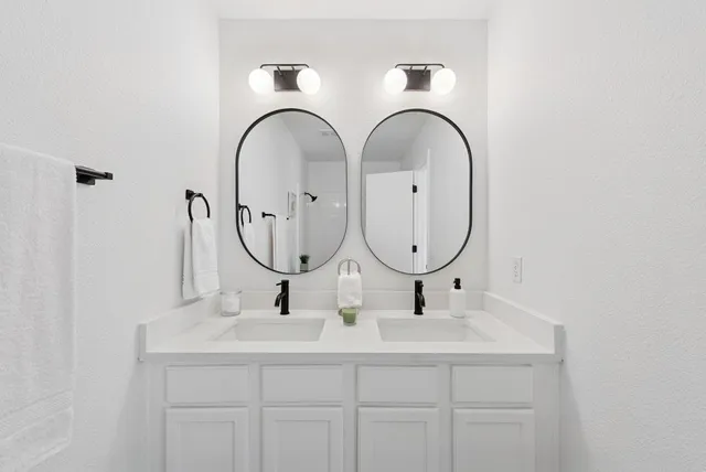 a bathroom with mirror and sink