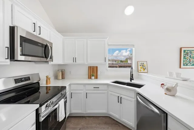 a kitchen with a sink stove and microwave