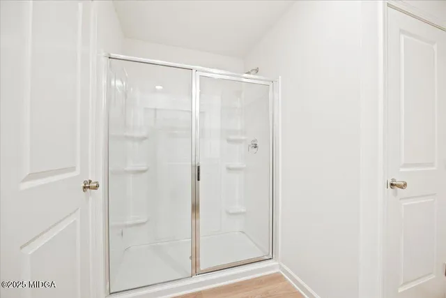 a bathroom with a glass shower door