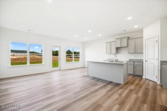 a view of kitchen with wooden floor and electronic appliances