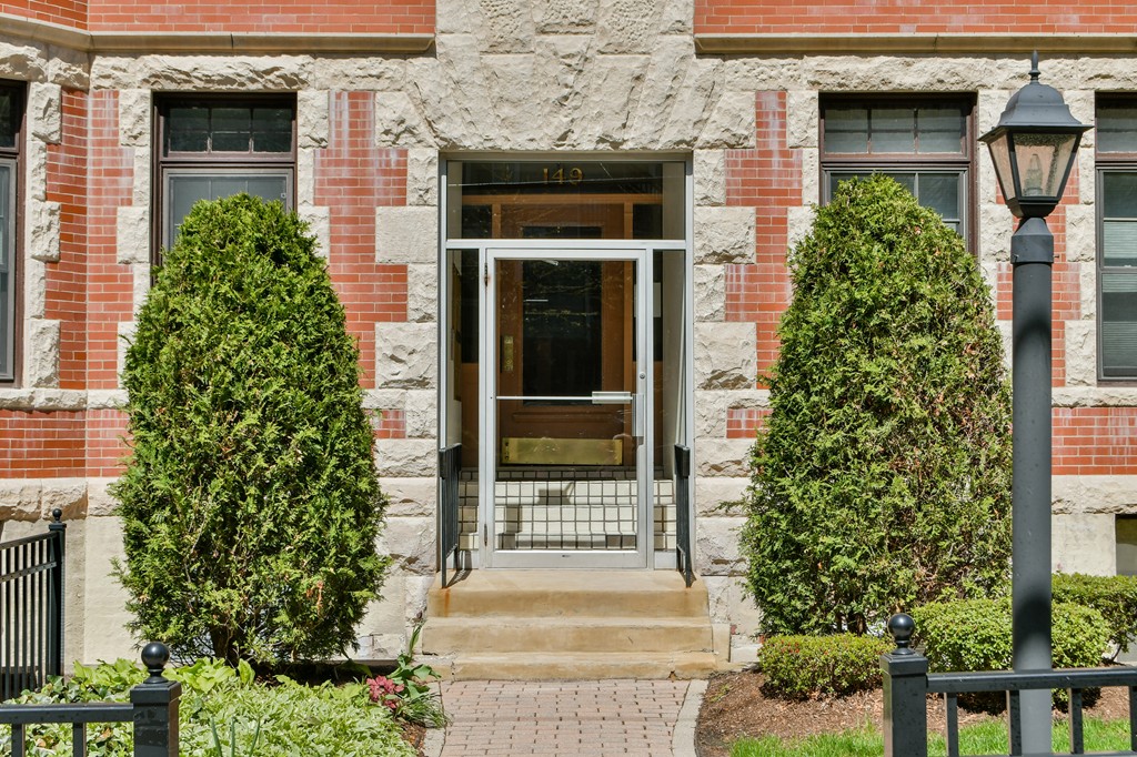 a front view of a house with plants