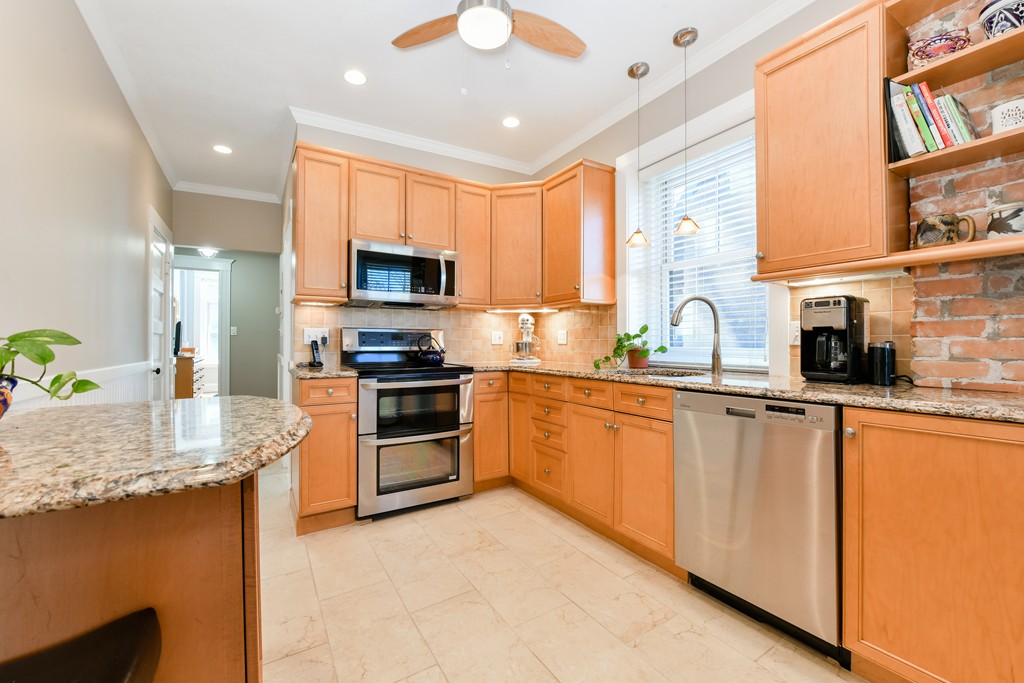 149 Winthrop Road, Unit 3 Brookline, MA 02445 - Photo 13 of 18 a kitchen with stainless steel appliances granite countertop a stove sink and microwave