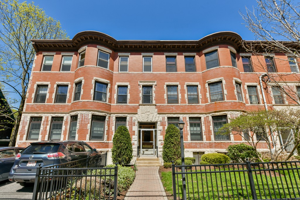 149 Winthrop Road, Unit 3 Brookline, MA 02445 - Photo 2 of 18 a front view of a residential apartment building with a yard