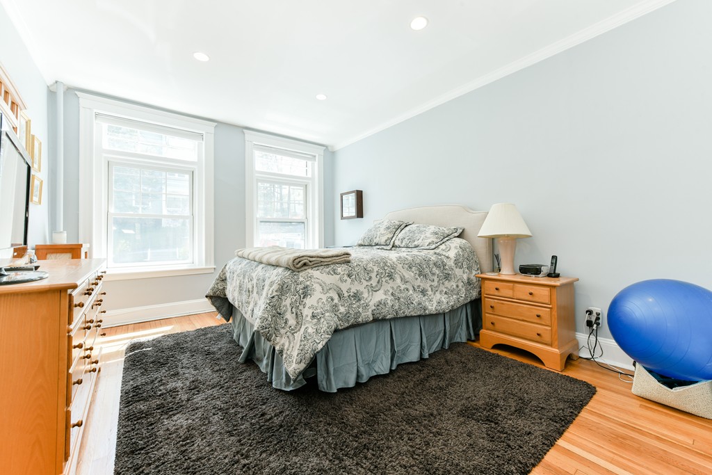 149 Winthrop Road, Unit 3 Brookline, MA 02445 - Photo 9 of 18 a bedroom with a bed and wooden floor