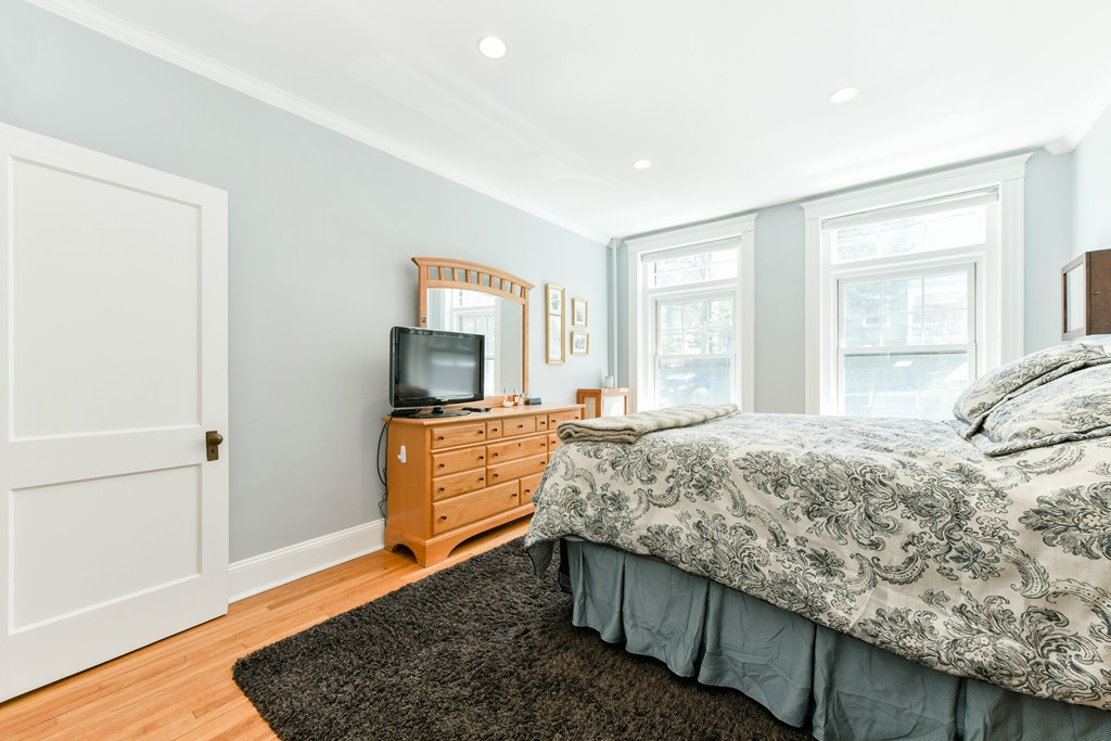 149 Winthrop Road, Unit 3 Brookline, MA 02445 - Photo 10 of 18 a bedroom with a bed and wooden floor