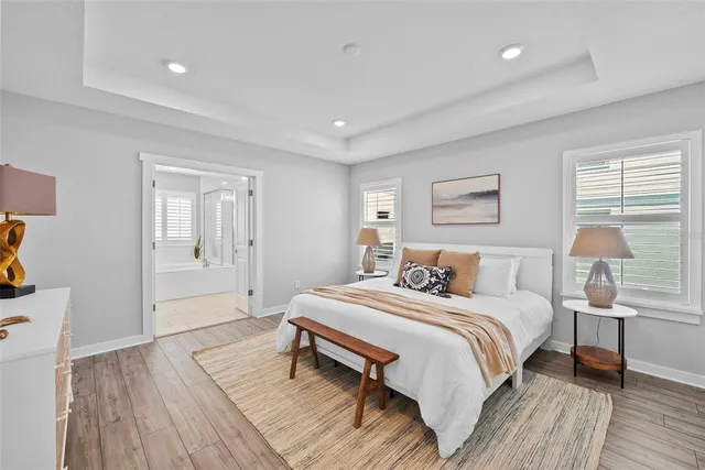 a bedroom with a bed and wooden floor