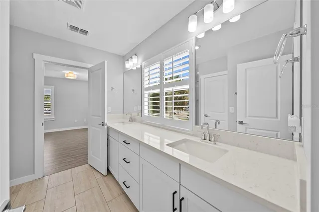 an empty room with a window and a ceiling fan