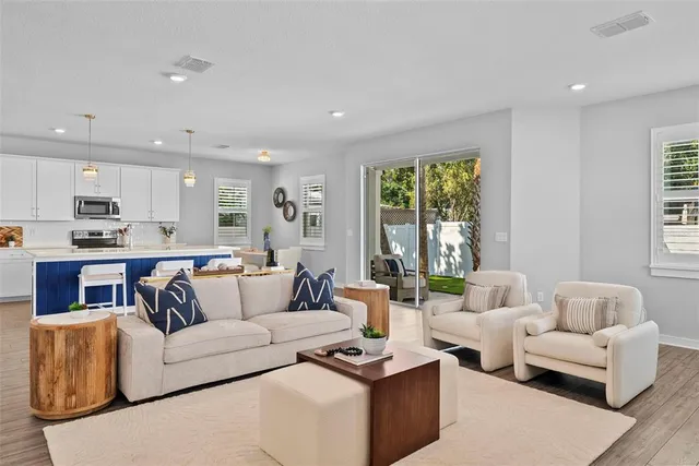 a living room with furniture and a large window