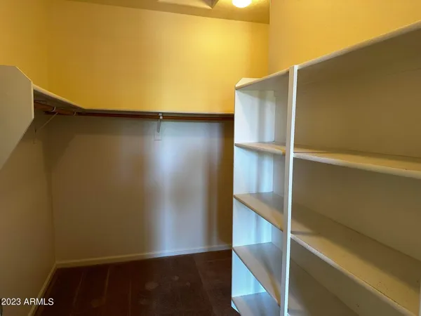 a view of closet with wooden floor