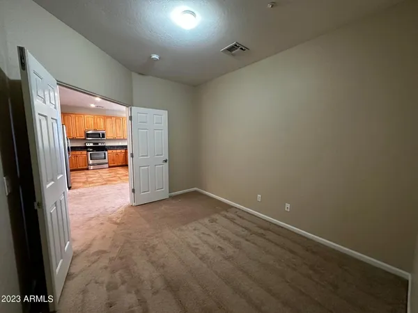 an empty room with large window and fire pit