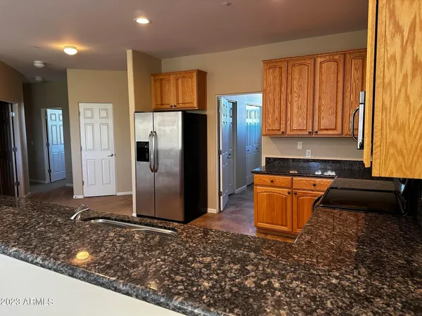 a kitchen with stainless steel appliances granite countertop a refrigerator and a stove