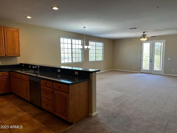 a kitchen with granite countertop a sink and a stove