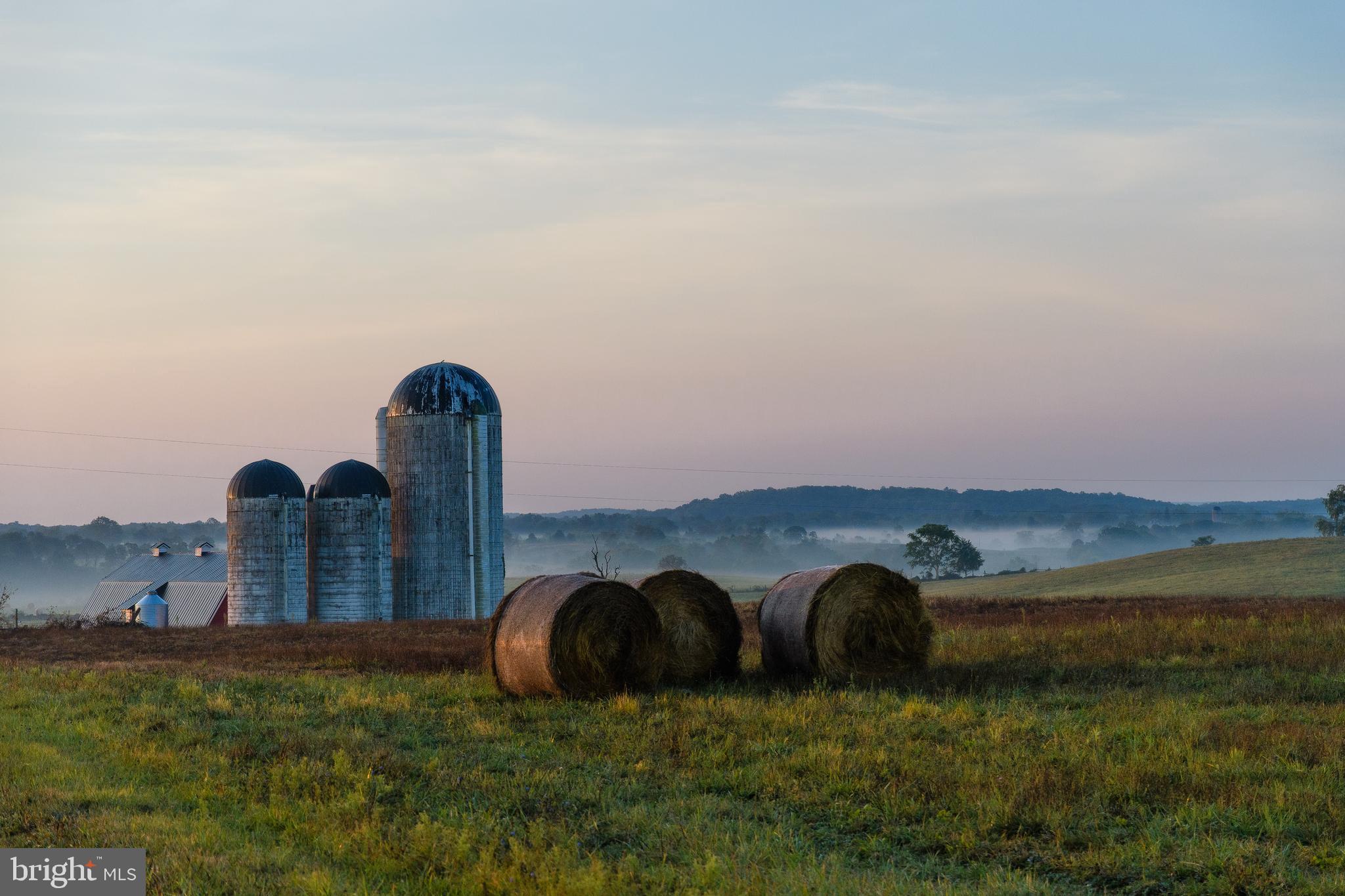 21091 Unison Road Middleburg, VA 20117 - Photo 54 of 65 View of silos in the distance with round bales.