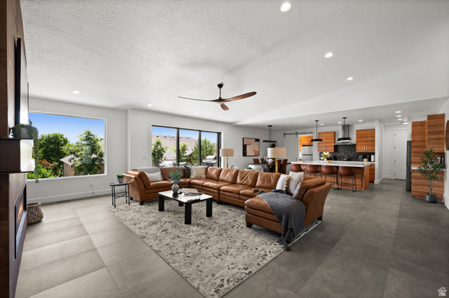507 West Windmill Gate Cove Draper, UT 84020 - Photo 7 of 46 Living area with a textured ceiling, a ceiling fan, and recessed lighting