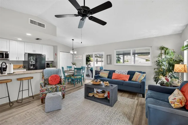 a very nice looking dining room with furniture a rug and wooden floor