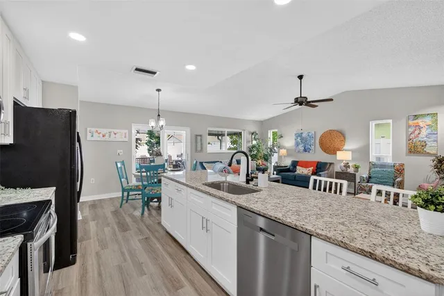a kitchen with granite countertop lots of counter top space and stainless steel appliances