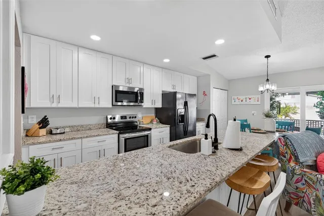 a kitchen with a refrigerator and a stove top oven