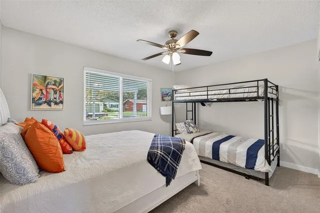 a bedroom with bed and a chandelier