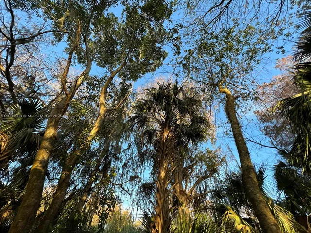 a backyard of a house with a yard and outdoor seating