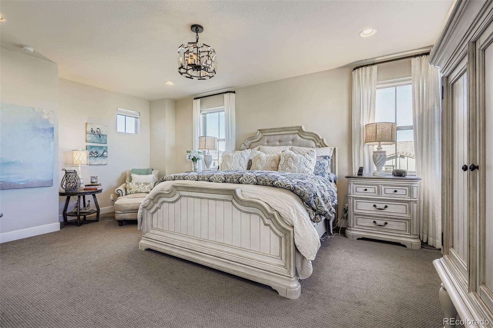 10414 Maplebrook Way Highlands Ranch, CO 80126 - Photo 17 of 45 a spacious bedroom with a bed and a window