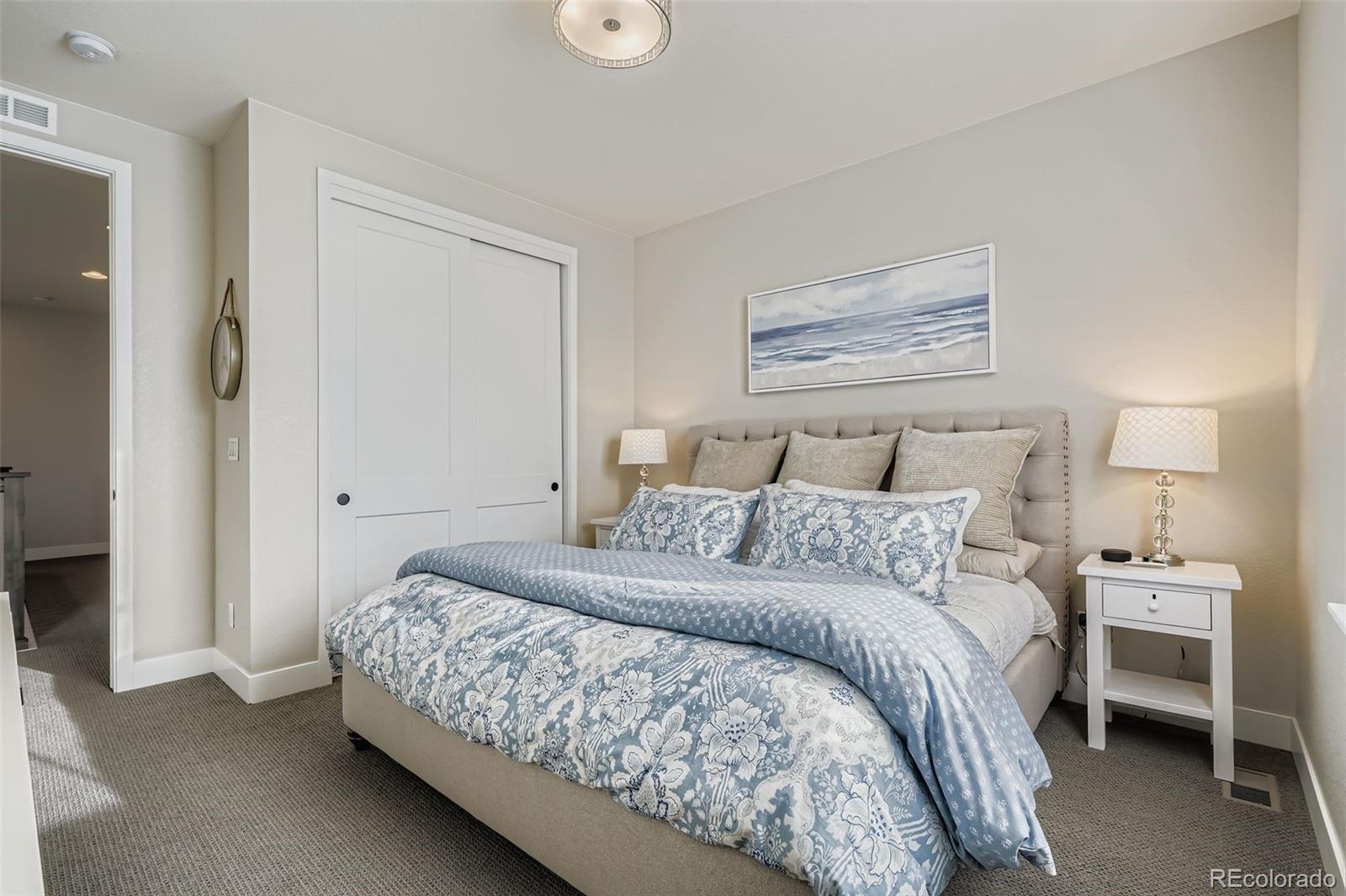 10414 Maplebrook Way Highlands Ranch, CO 80126 - Photo 22 of 45 a bedroom with a bed and a lamp