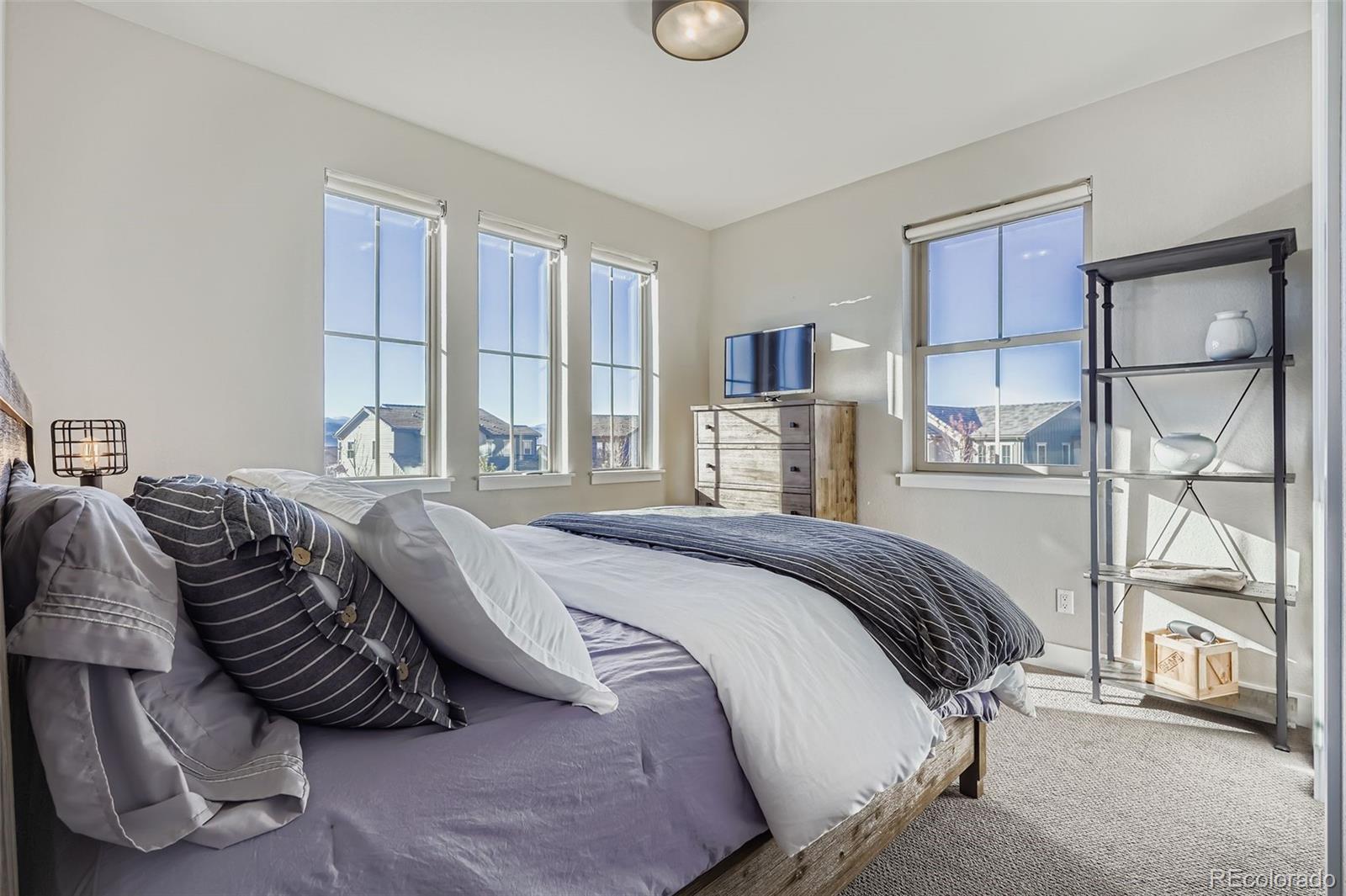 10414 Maplebrook Way Highlands Ranch, CO 80126 - Photo 25 of 45 a bedroom with a large bed and a window