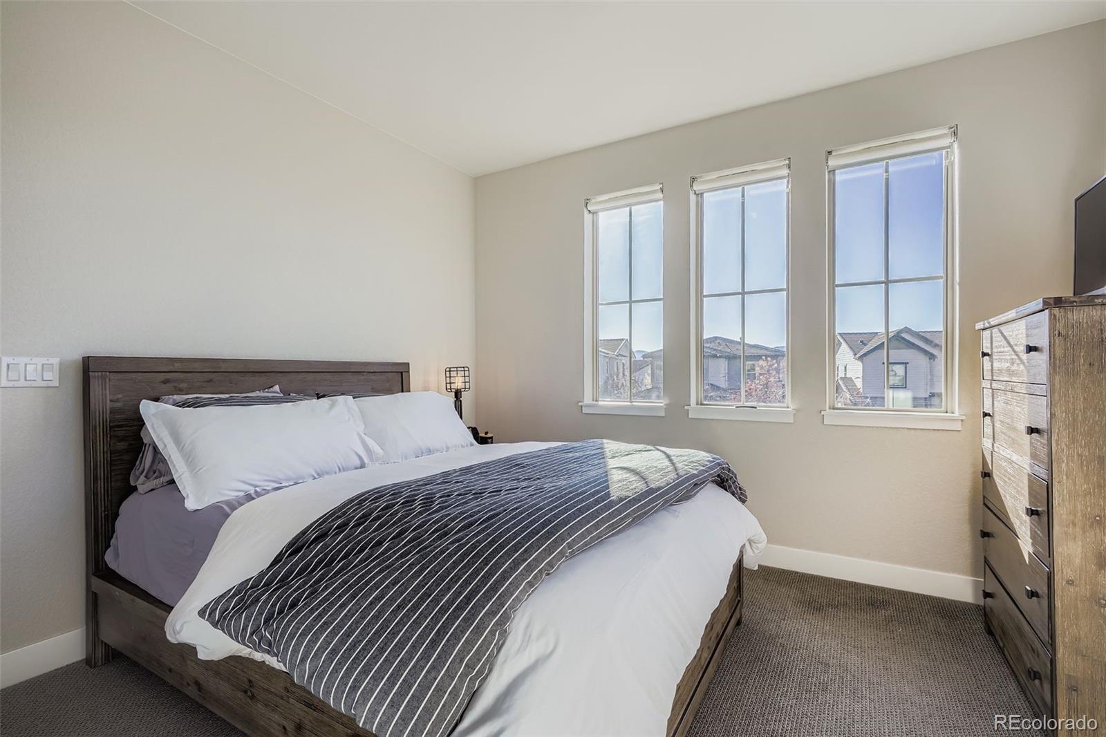 10414 Maplebrook Way Highlands Ranch, CO 80126 - Photo 26 of 45 a bedroom with a bed and a window