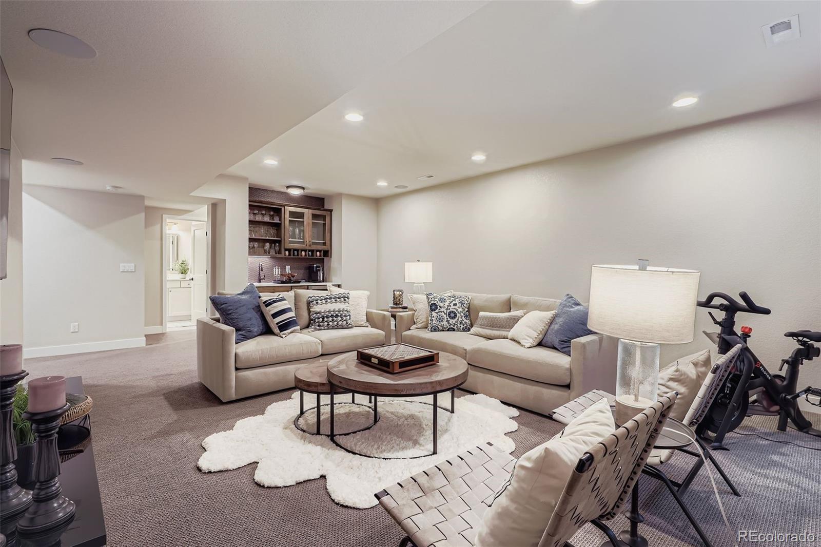 10414 Maplebrook Way Highlands Ranch, CO 80126 - Photo 27 of 45 a living room with furniture and a wooden floor