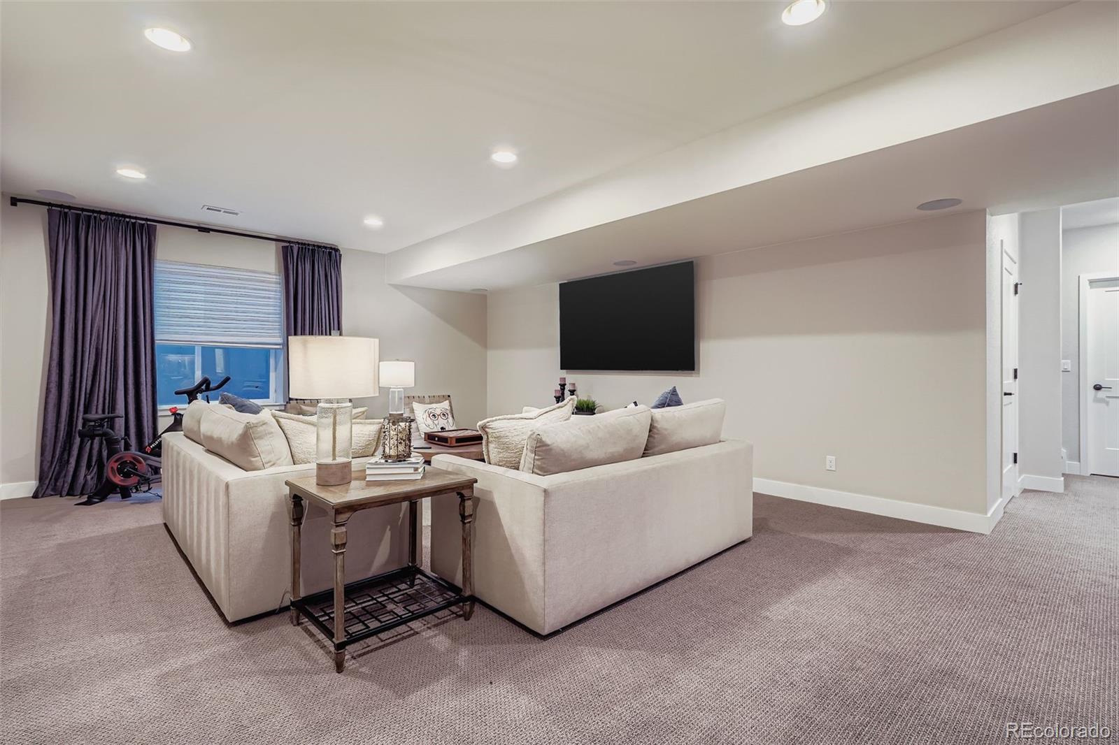 10414 Maplebrook Way Highlands Ranch, CO 80126 - Photo 28 of 45 a living room with furniture and a flat screen tv