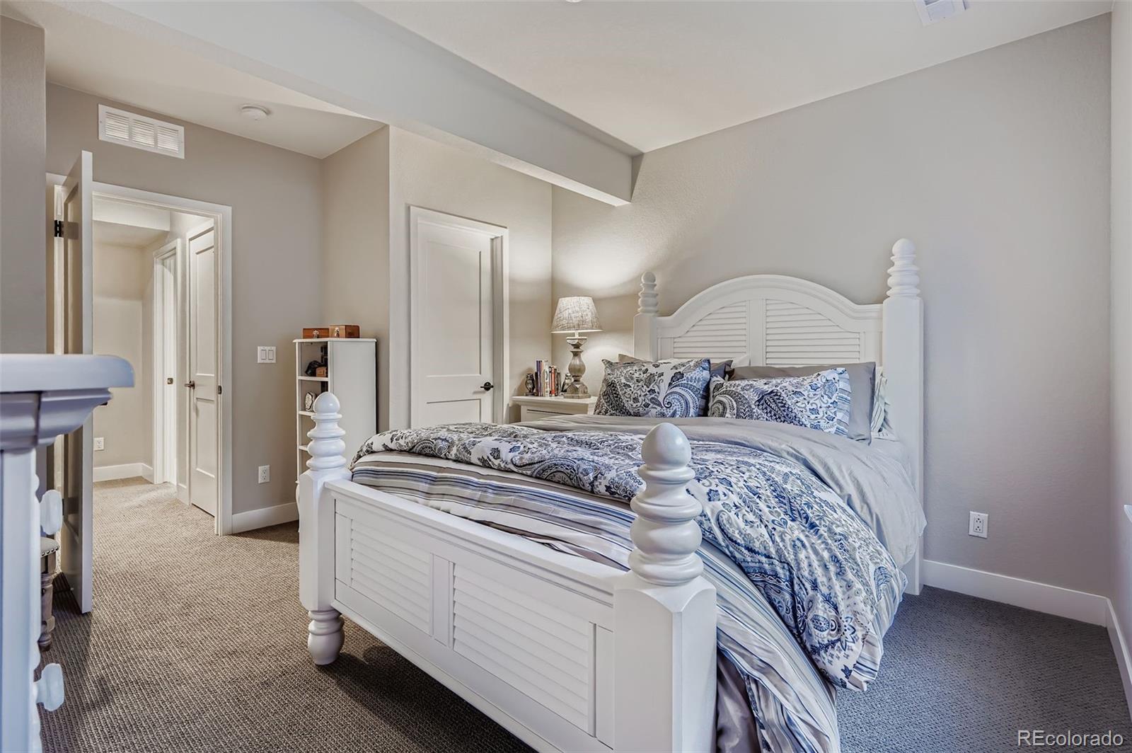 10414 Maplebrook Way Highlands Ranch, CO 80126 - Photo 29 of 45 a bedroom with a bed and a mirror