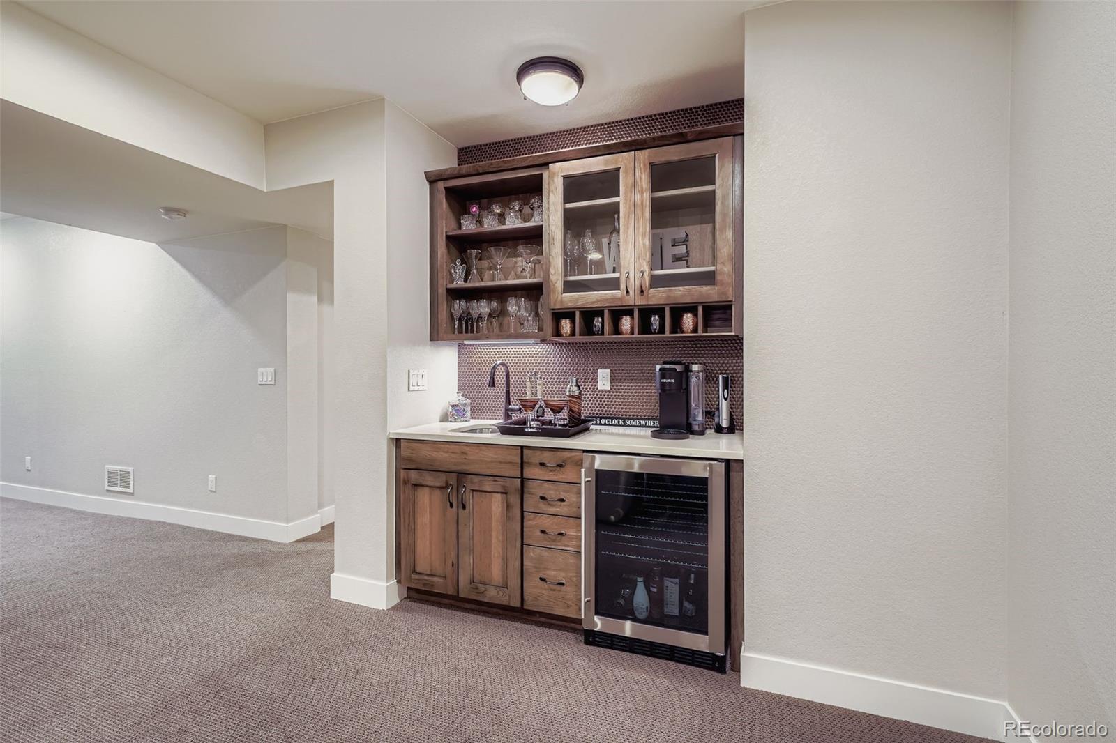 10414 Maplebrook Way Highlands Ranch, CO 80126 - Photo 31 of 45 a kitchen with stainless steel appliances a stove and cabinets