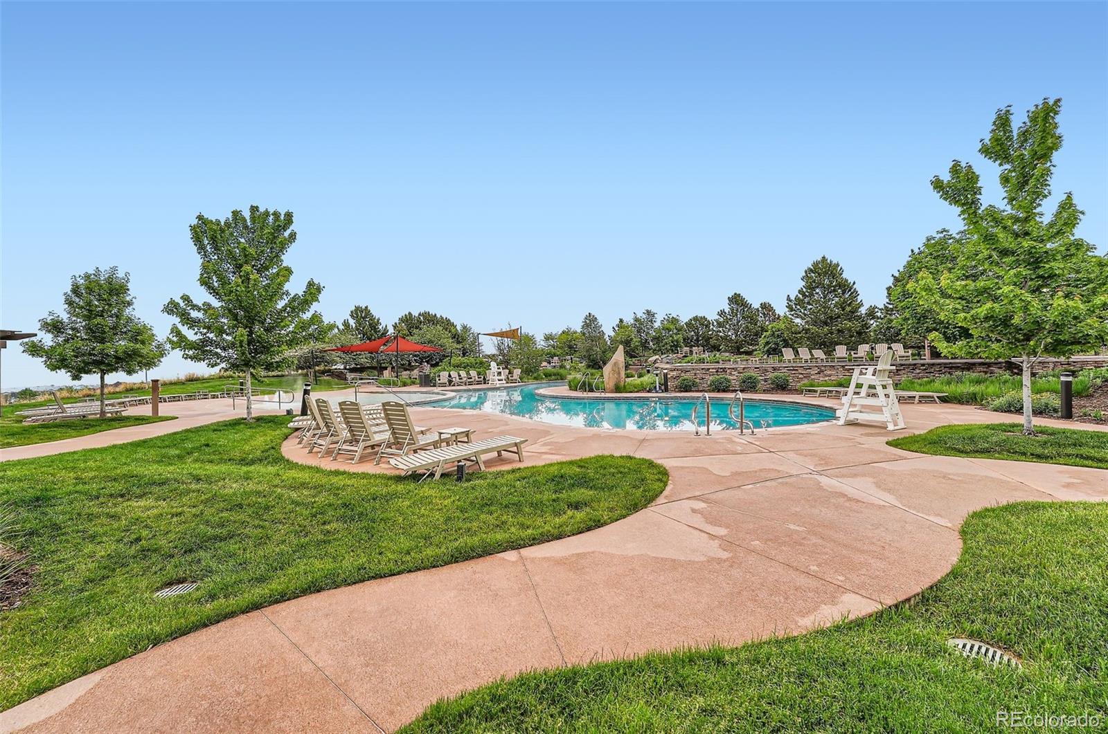 10414 Maplebrook Way Highlands Ranch, CO 80126 - Photo 40 of 45 a view of a swimming pool and a yard