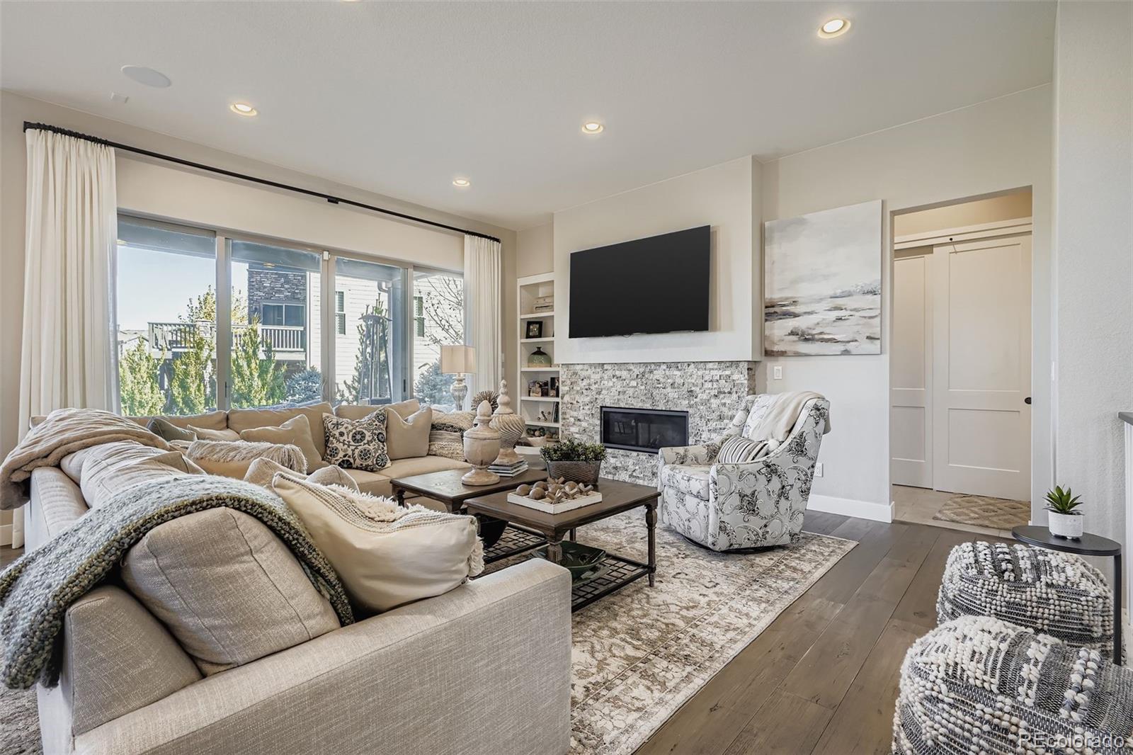 10414 Maplebrook Way Highlands Ranch, CO 80126 - Photo 8 of 45 a living room with furniture fireplace and a flat screen tv