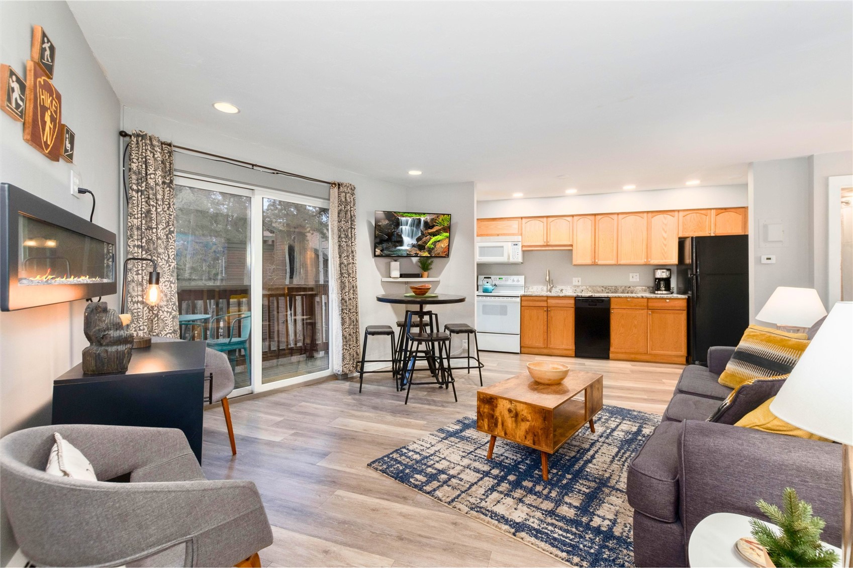 1140 Ski Hill Road, Unit 27 Breckenridge, CO 80424 - Photo 1 of 26 a living room with furniture kitchen view and a large window