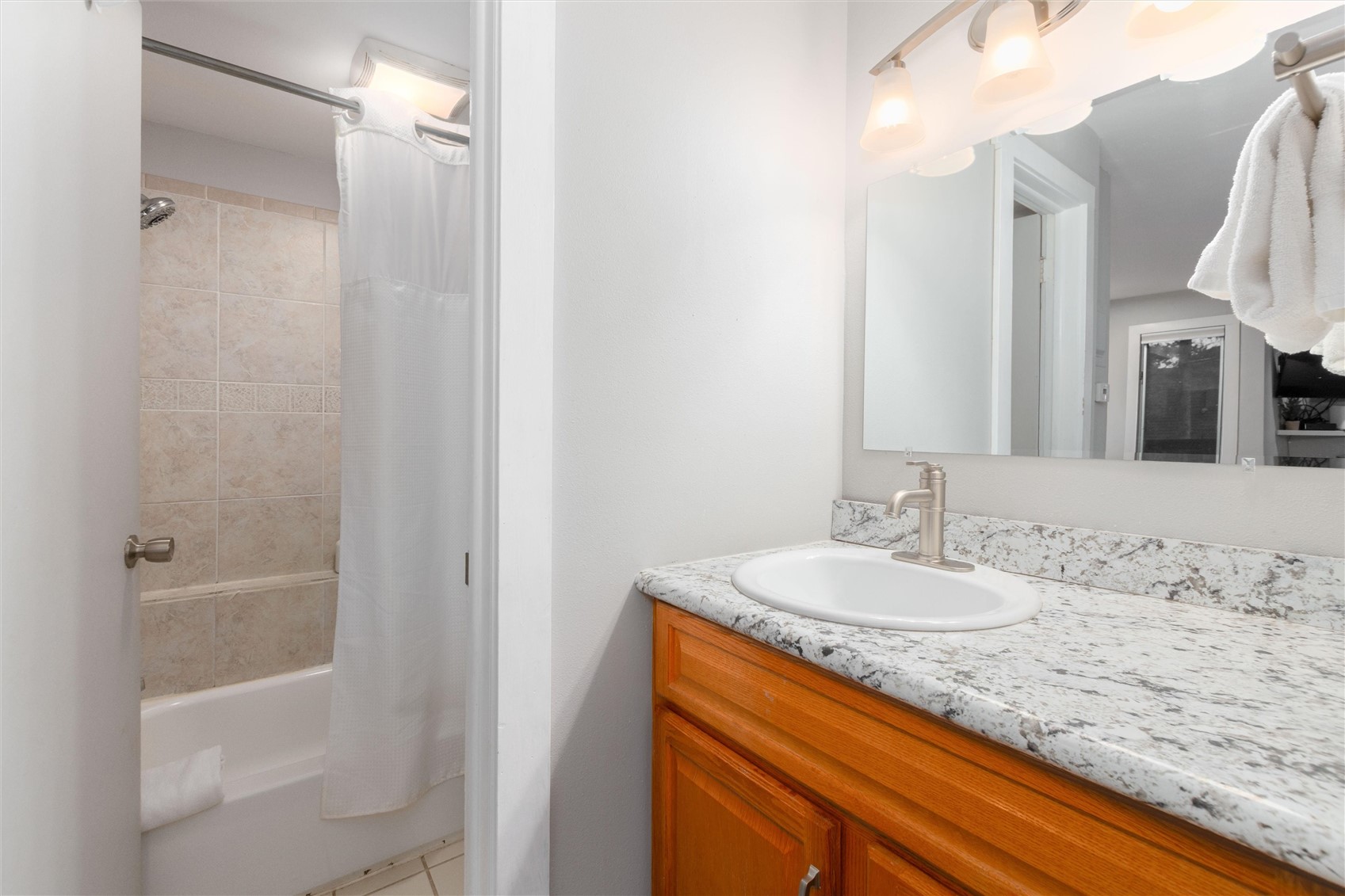 1140 Ski Hill Road, Unit 27 Breckenridge, CO 80424 - Photo 12 of 26 a bathroom with a granite countertop sink and a mirror