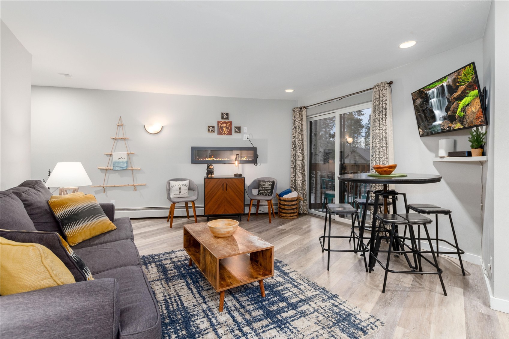1140 Ski Hill Road, Unit 27 Breckenridge, CO 80424 - Photo 3 of 26 a living room with furniture and wooden floor