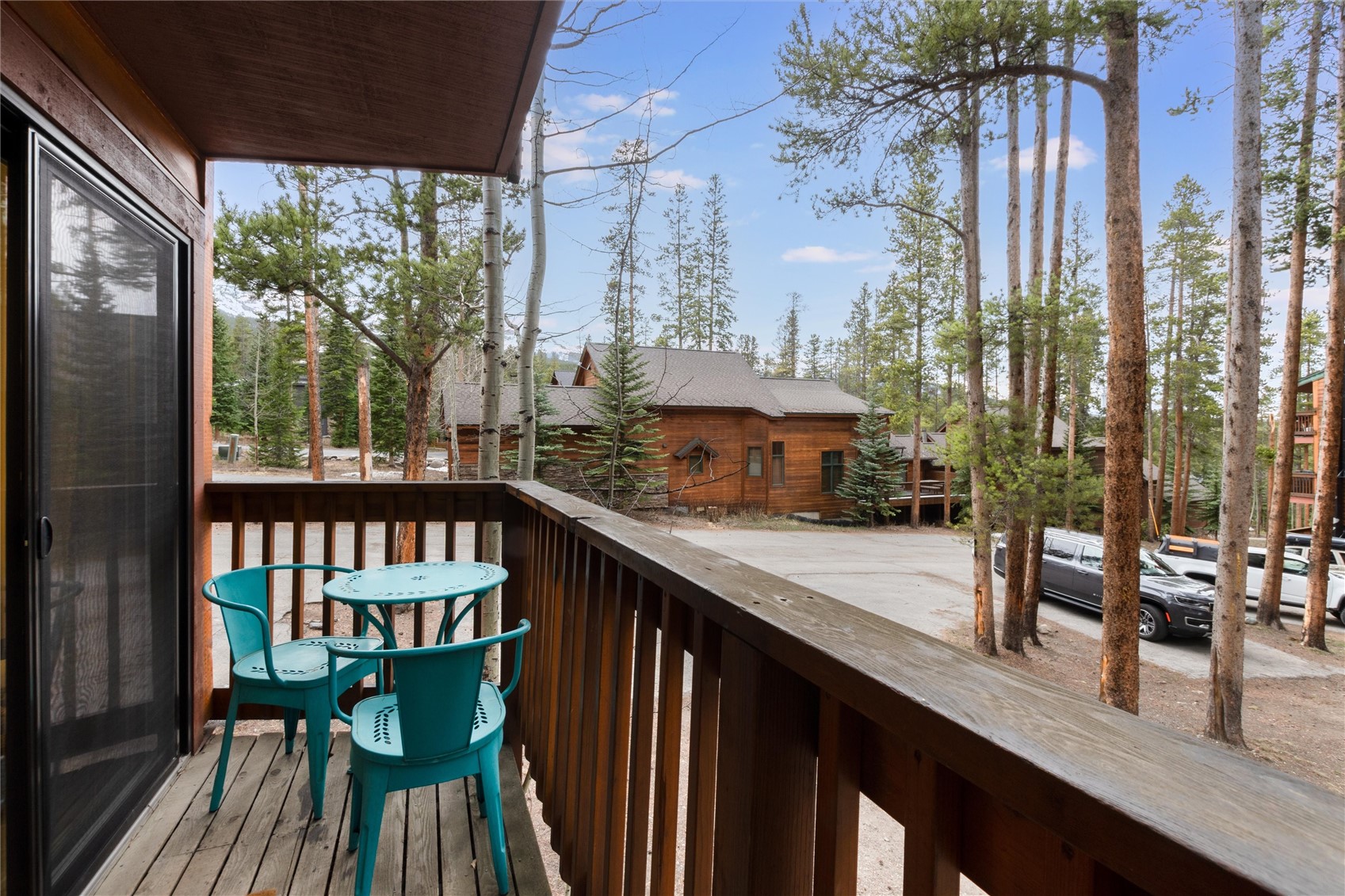1140 Ski Hill Road, Unit 27 Breckenridge, CO 80424 - Photo 8 of 26 a view of a chairs and table in patio with wooden fence