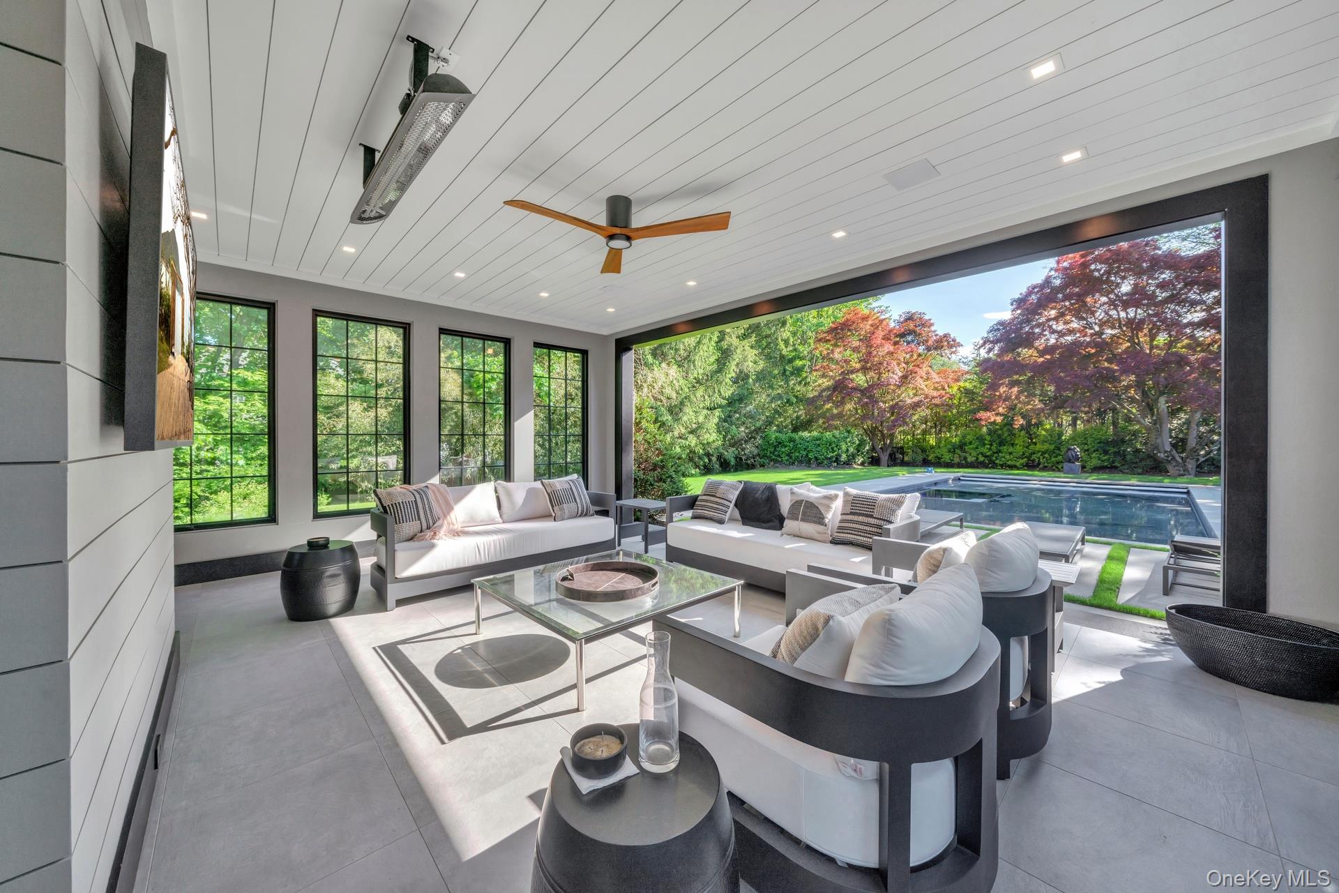 64 Cushman Road Scarsdale, NY 10583 - Photo 30 of 32 a living room with patio furniture and a large window