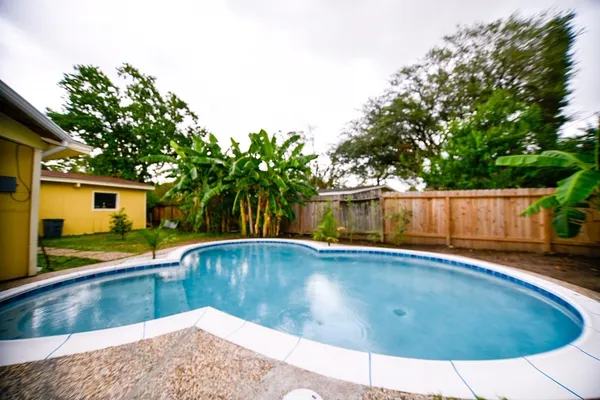 a view of a swimming pool with a patio