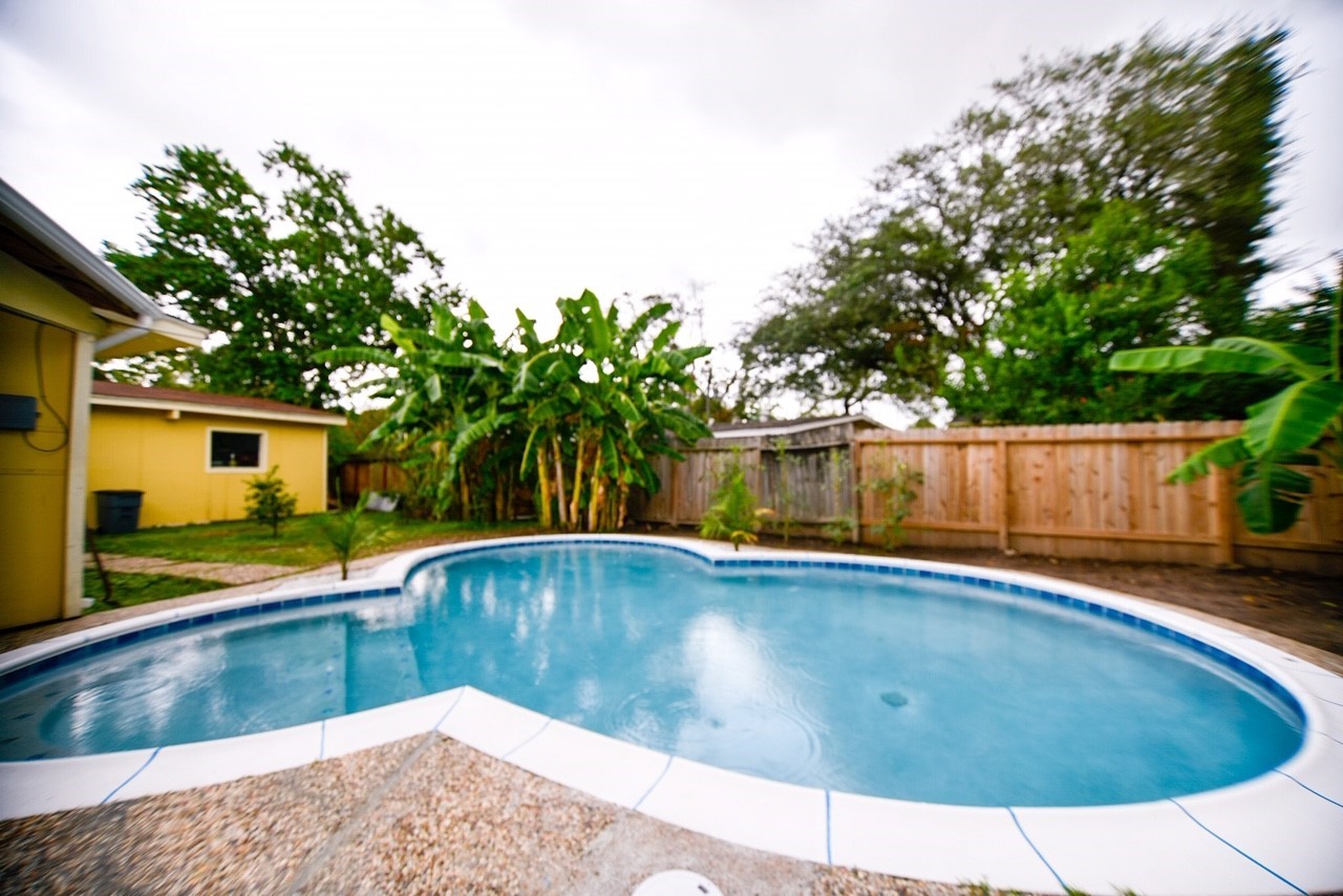 a view of a swimming pool with a patio