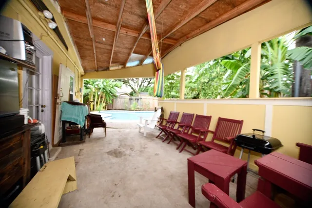 a view of a house with swimming pool and sitting area