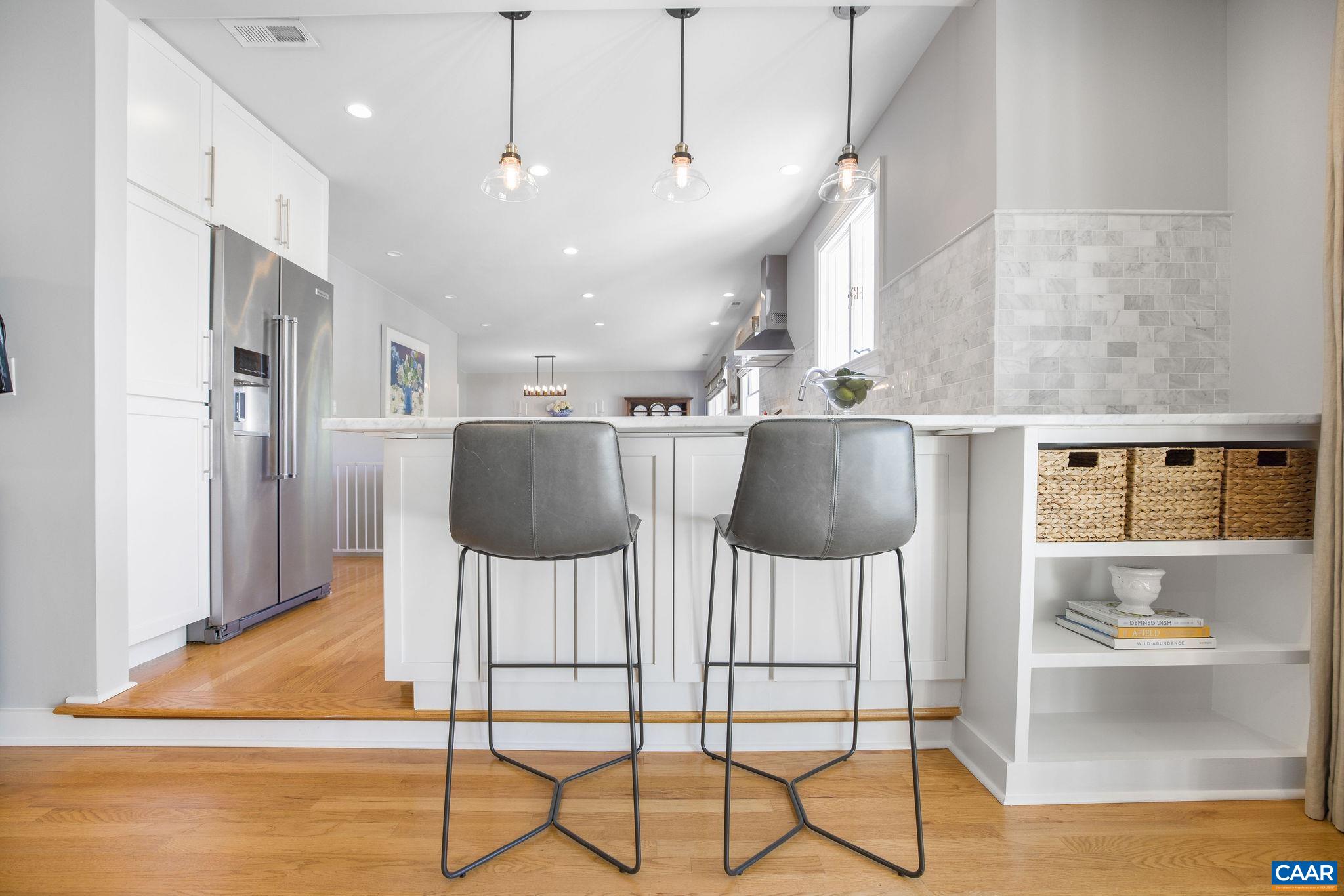 1504 Rugby Avenue Charlottesville, VA 22903 - Photo 12 of 51 a kitchen with stainless steel appliances kitchen island granite countertop a dining table chairs and granite counter tops