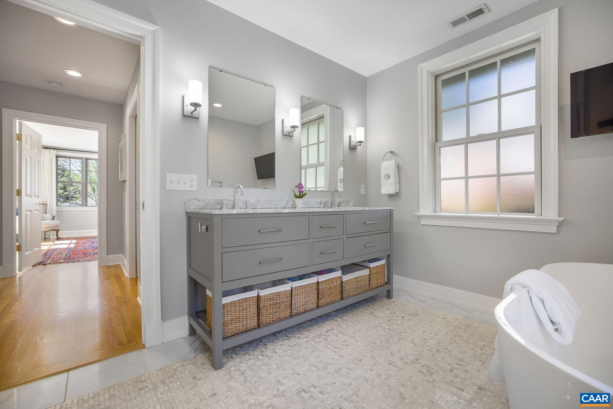 1504 Rugby Avenue Charlottesville, VA 22903 - Photo 22 of 51 a spacious bathroom with a tub sink and mirror