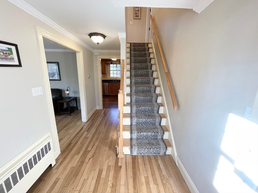71 Morse Street Sharon, MA 02067 - Photo 15 of 40 a view of a hallway with wooden floor and staircase
