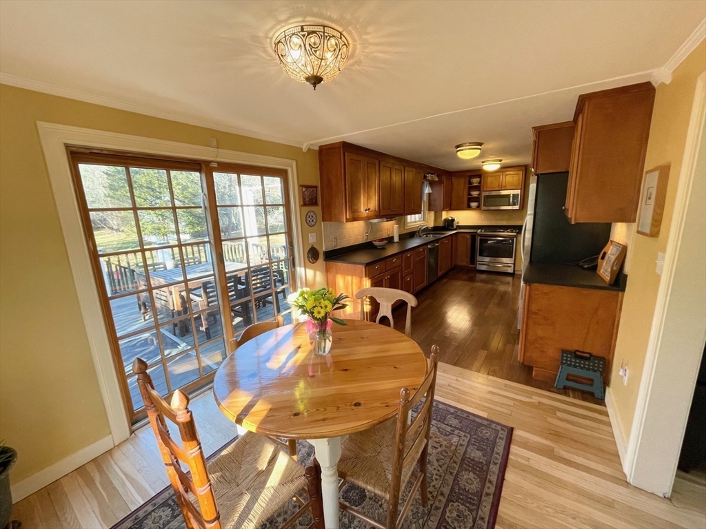 71 Morse Street Sharon, MA 02067 - Photo 3 of 40 a view of a dining room with furniture a chandelier and wooden floor