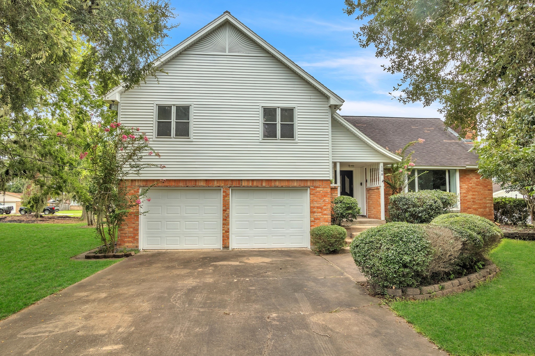 a view of a house with a yard and garage
