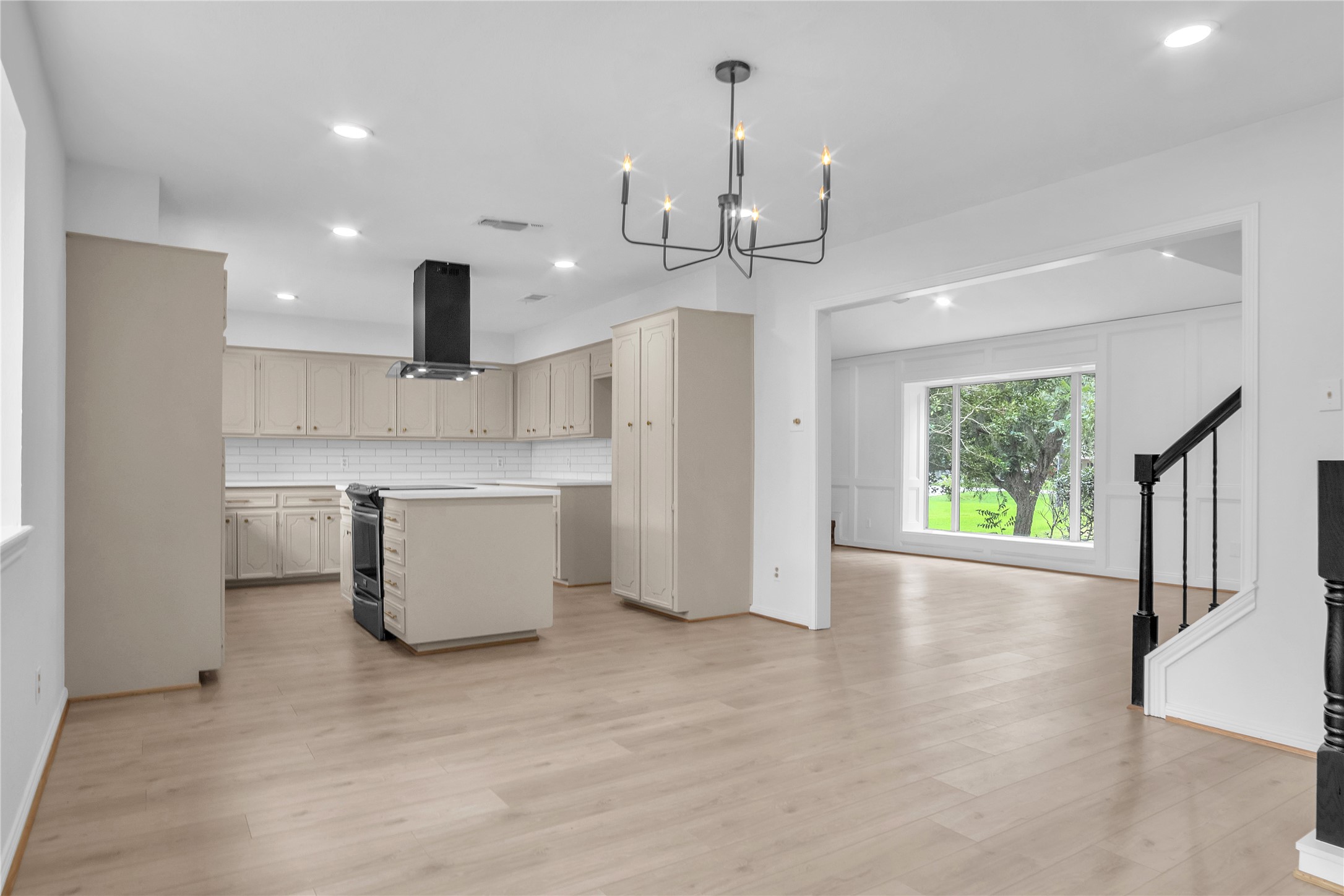 108 Woodland Road Lake Jackson, TX 77566 - Photo 11 of 50 a large kitchen with kitchen island a island a sink a window and stainless steel appliances
