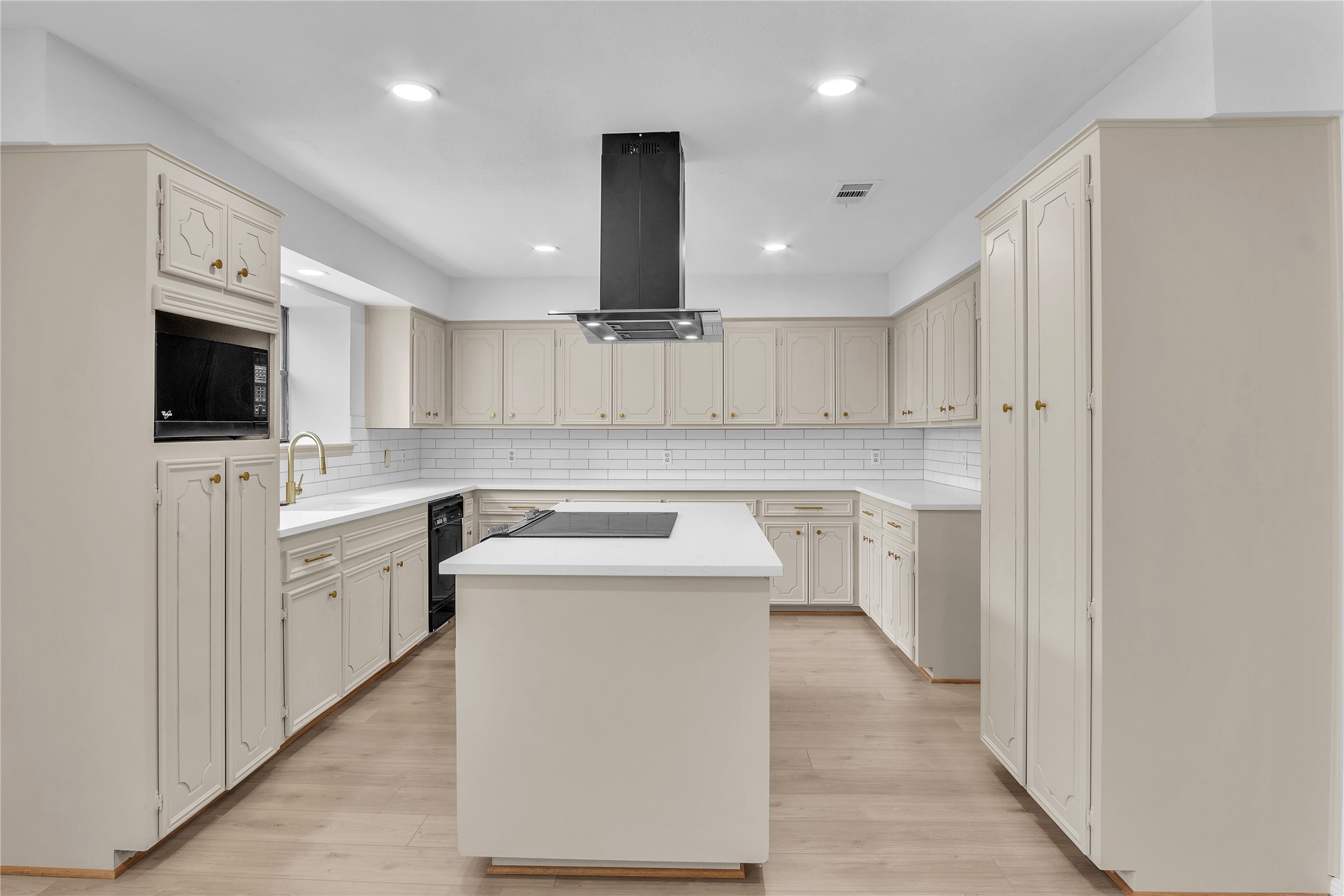 108 Woodland Road Lake Jackson, TX 77566 - Photo 12 of 50 a kitchen with white cabinets and appliances