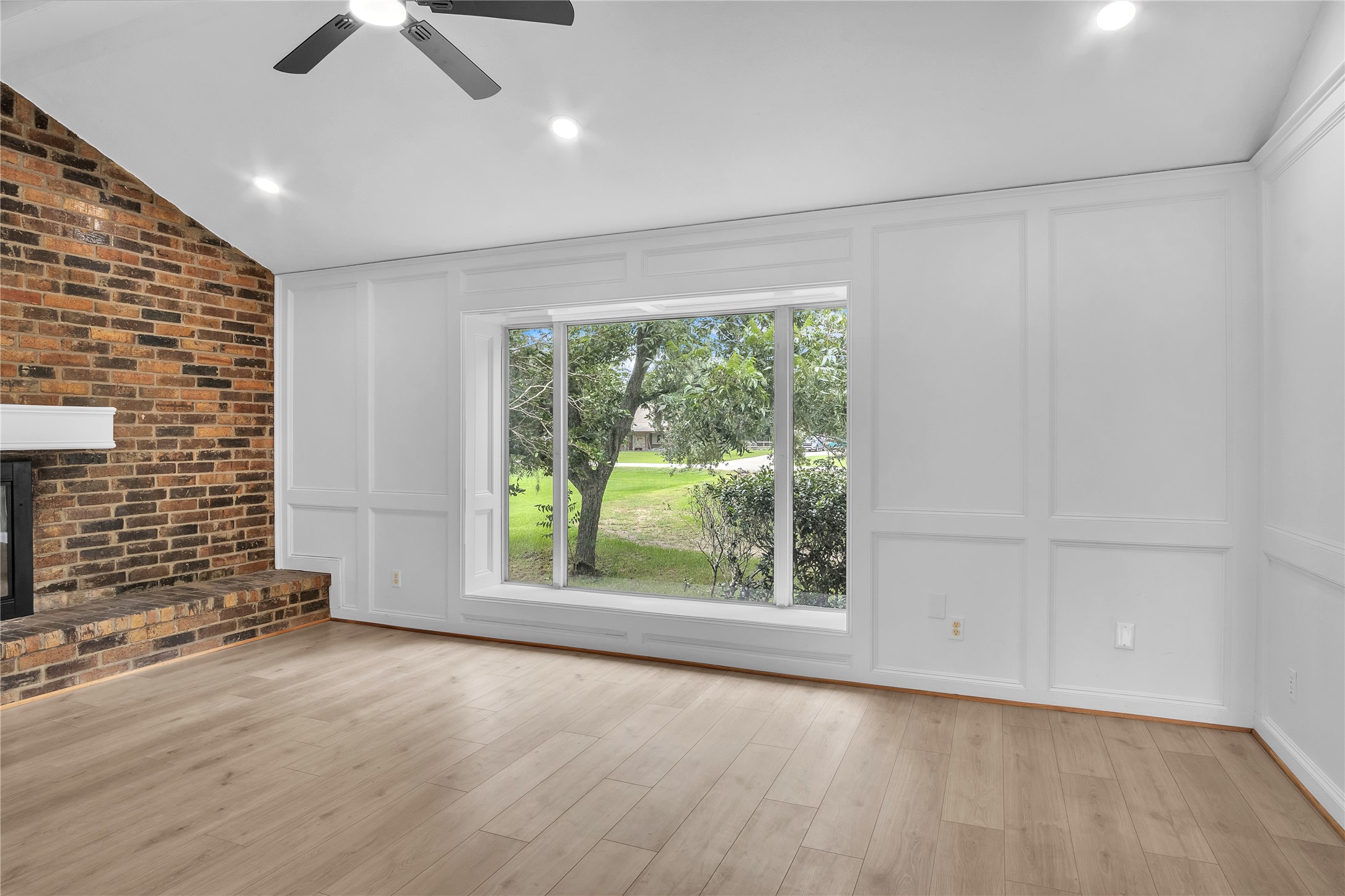 108 Woodland Road Lake Jackson, TX 77566 - Photo 9 of 50 a view of an empty room with a window and wooden floor